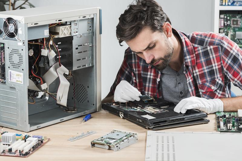 computer diagnostic technician, in Brooklyn NY repairing a laptop and computer