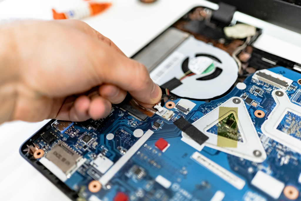  A computer technician repairing a motherboard during a hardware repair service