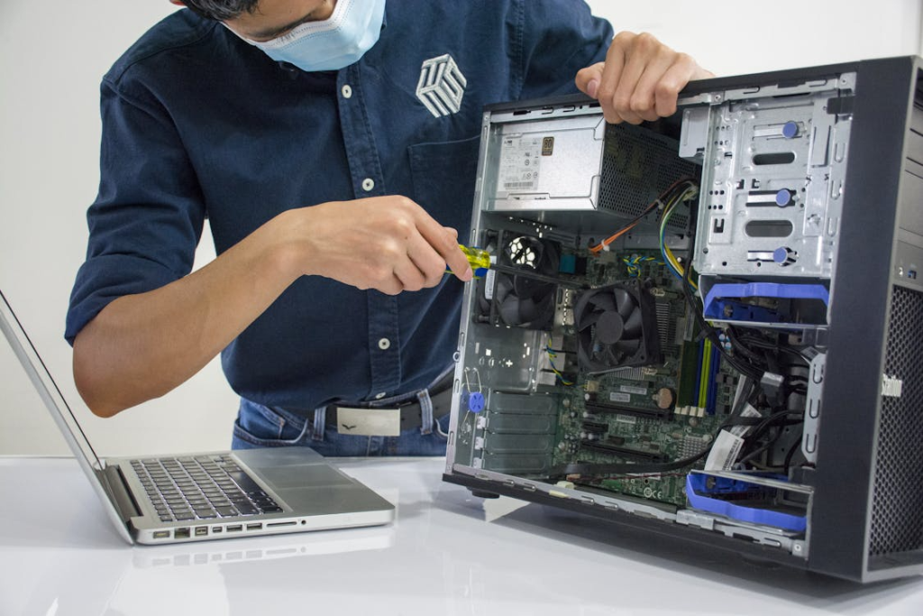 A technician inspecting CPU wiring and internal computer components during hardware diagnostics