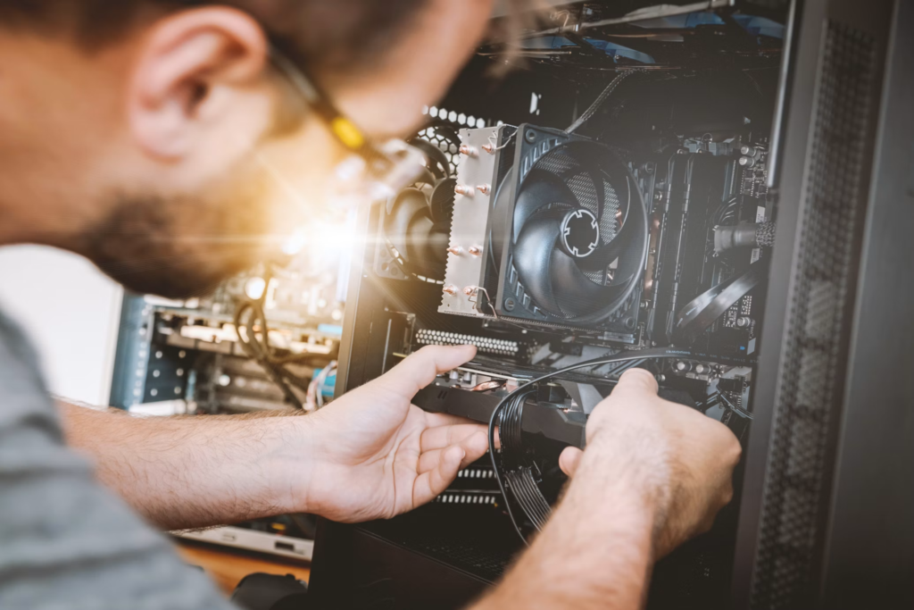 Technician working inside a desktop computer during 24/7 computer repair service in Brooklyn