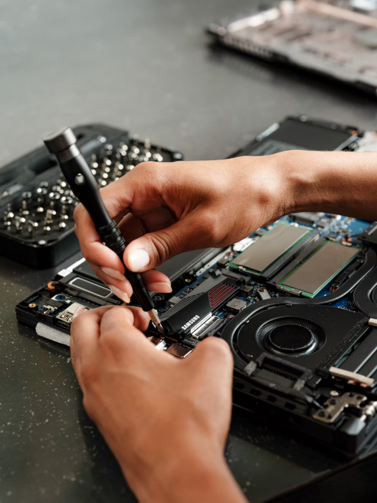 Technician repairing internal computer components during an emergency computer repair service